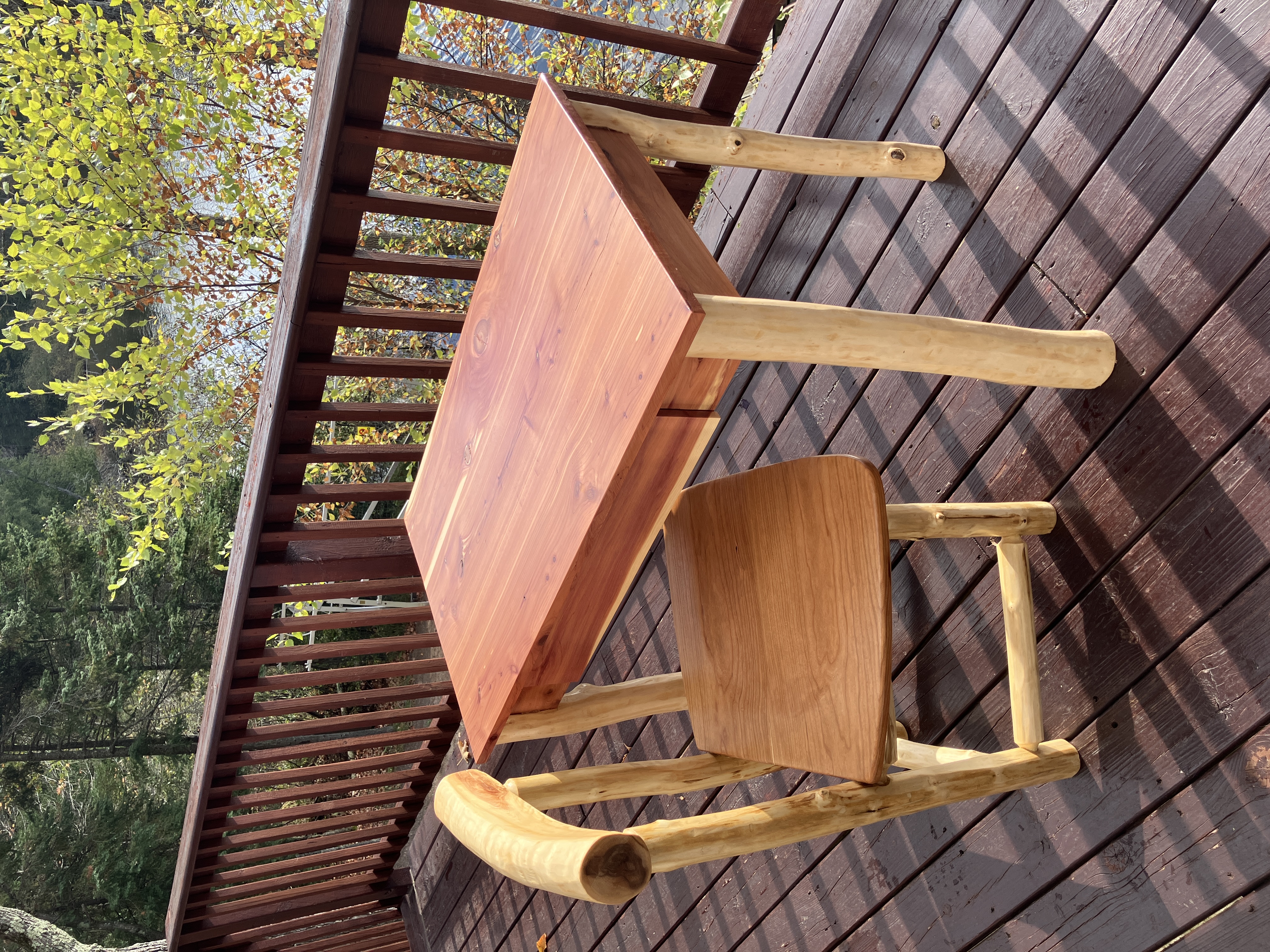 Angled view of cedar desk with chair