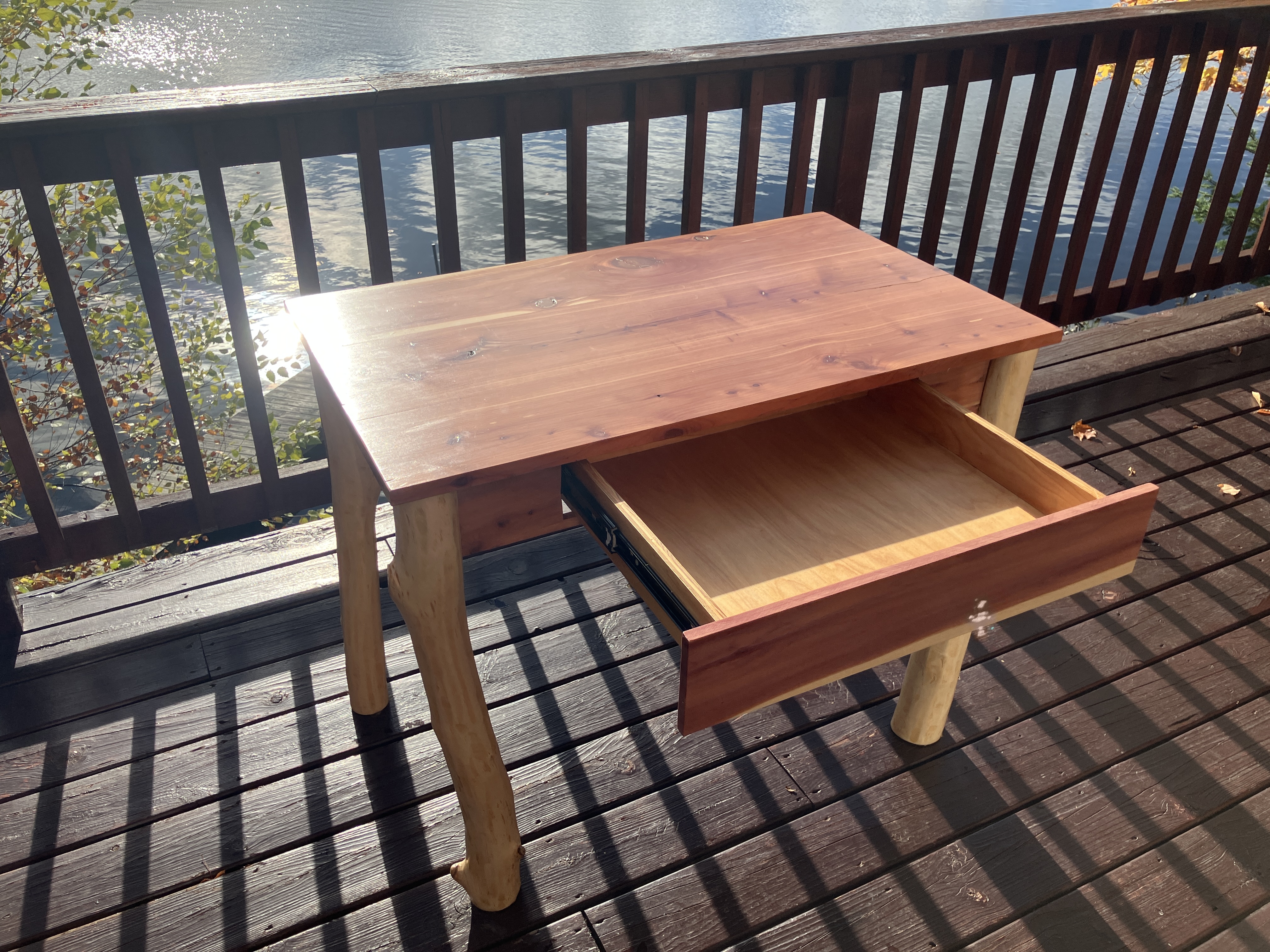 Cedar desk with open drawer in natural light