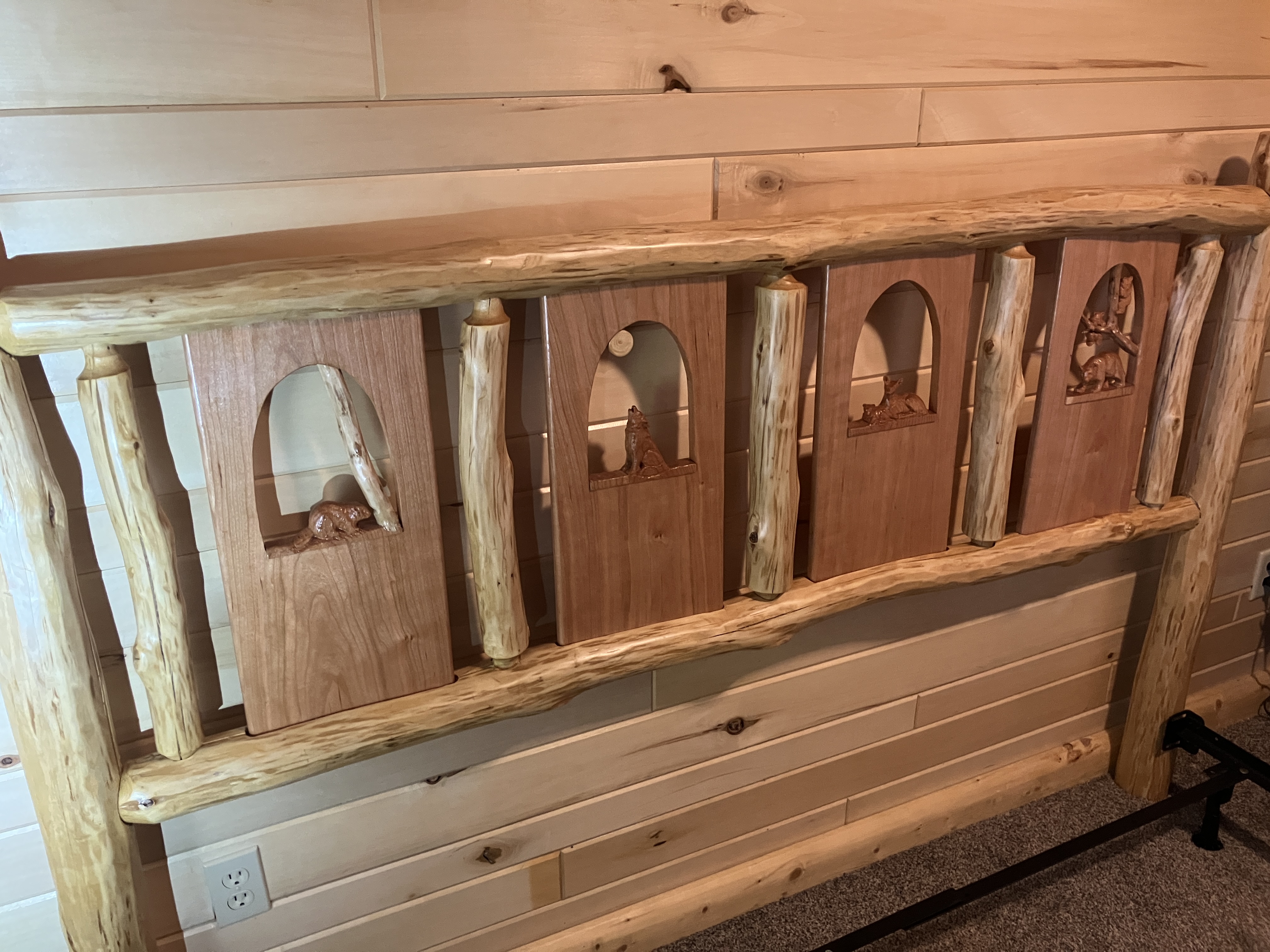 Left-side view of log headboard showing attachment to black metal bed frame