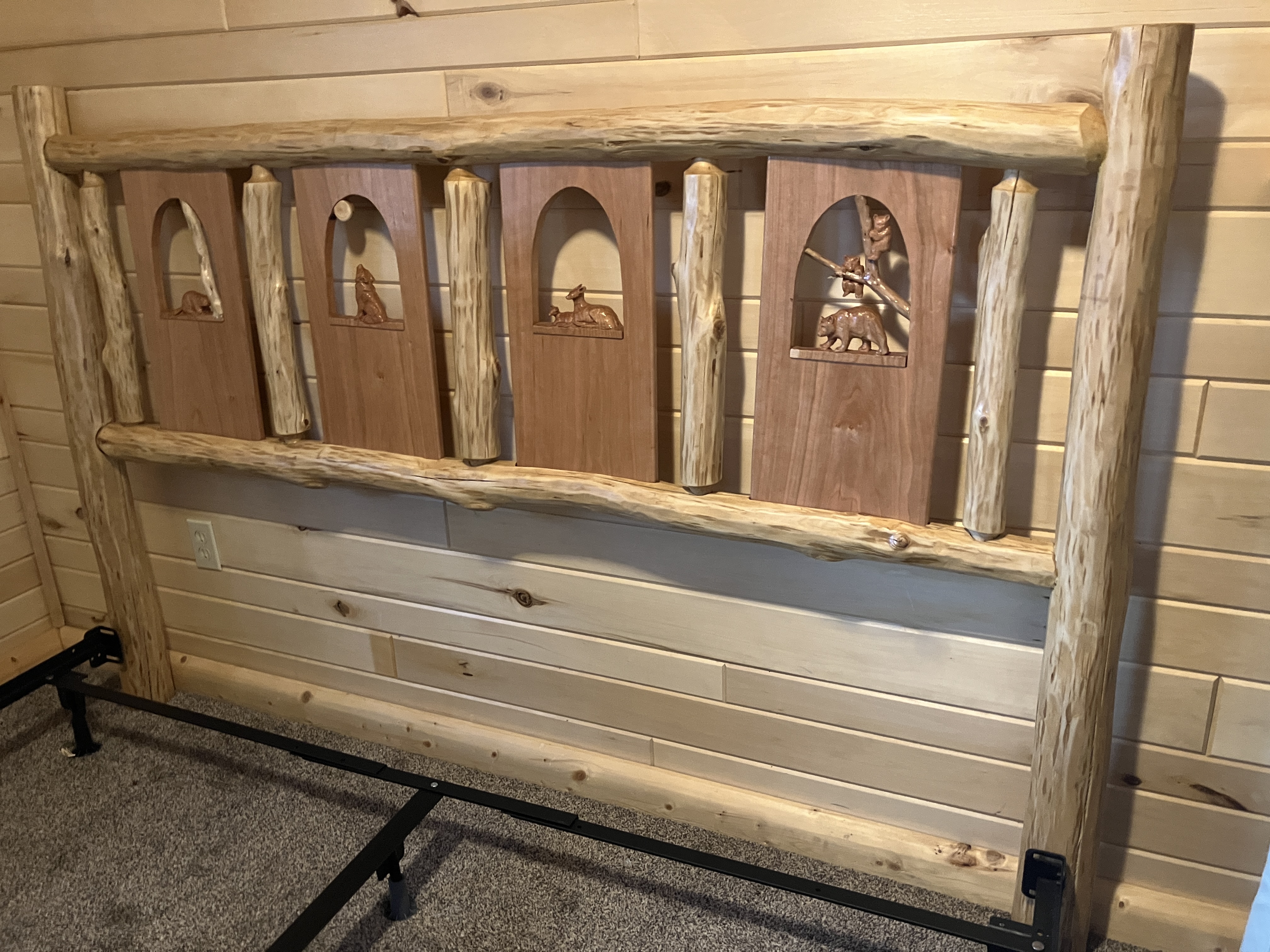 Right-side view of log headboard showing attachment points to black metal bed frame