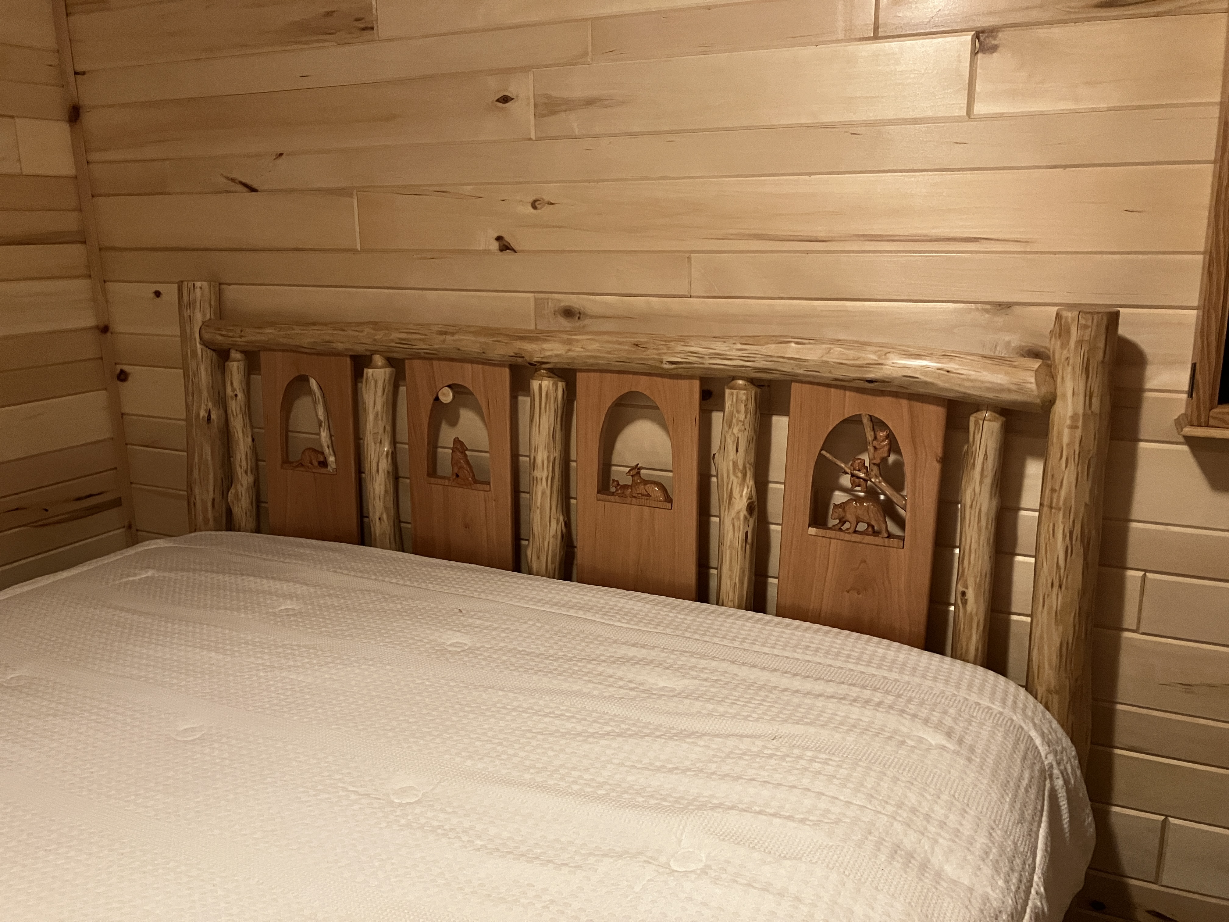 Right-side angle of log headboard showing log structure and craftsmanship
