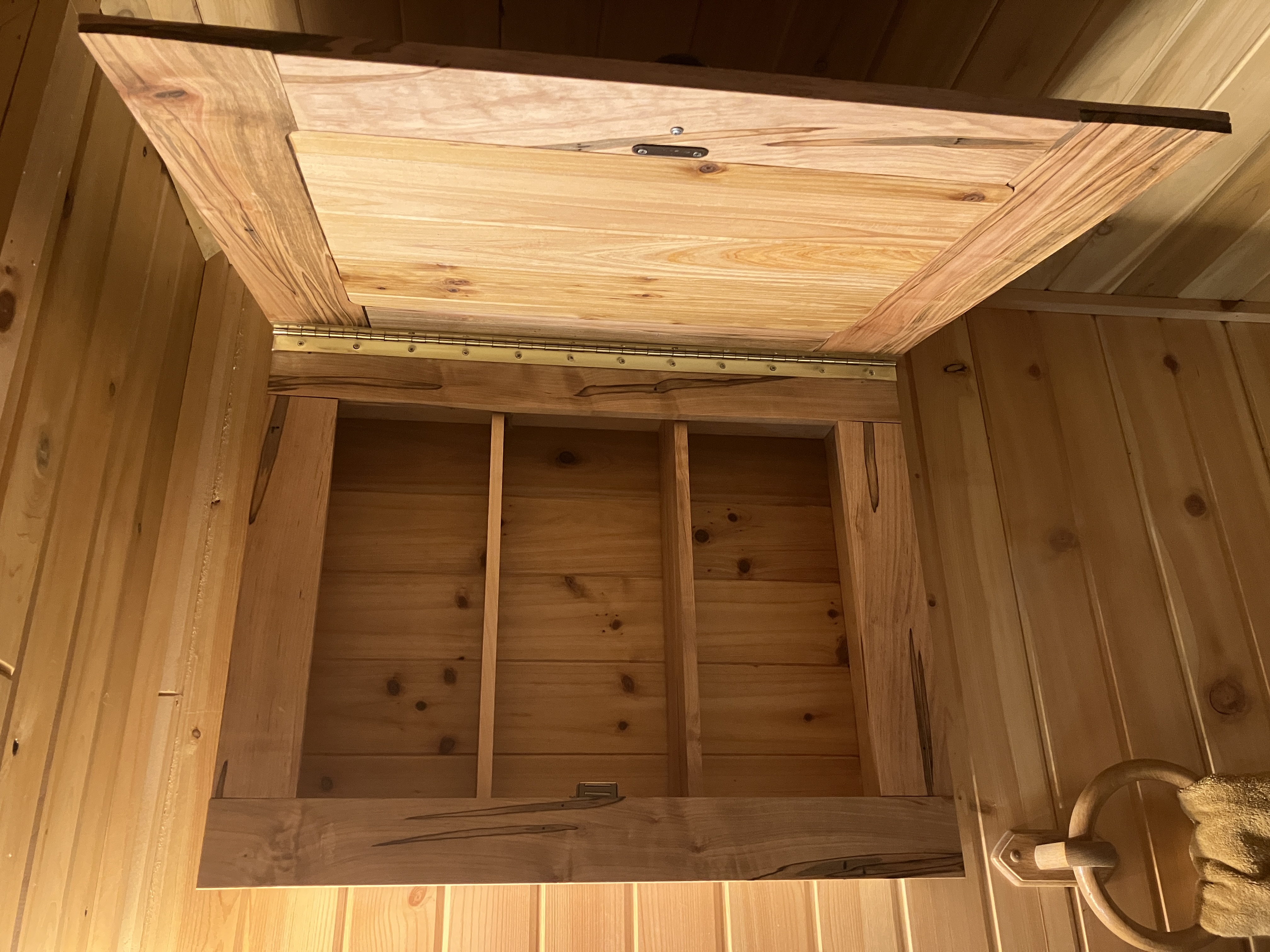 Close-up of handmade rustic medicine cabinet installed in cabin bathroom