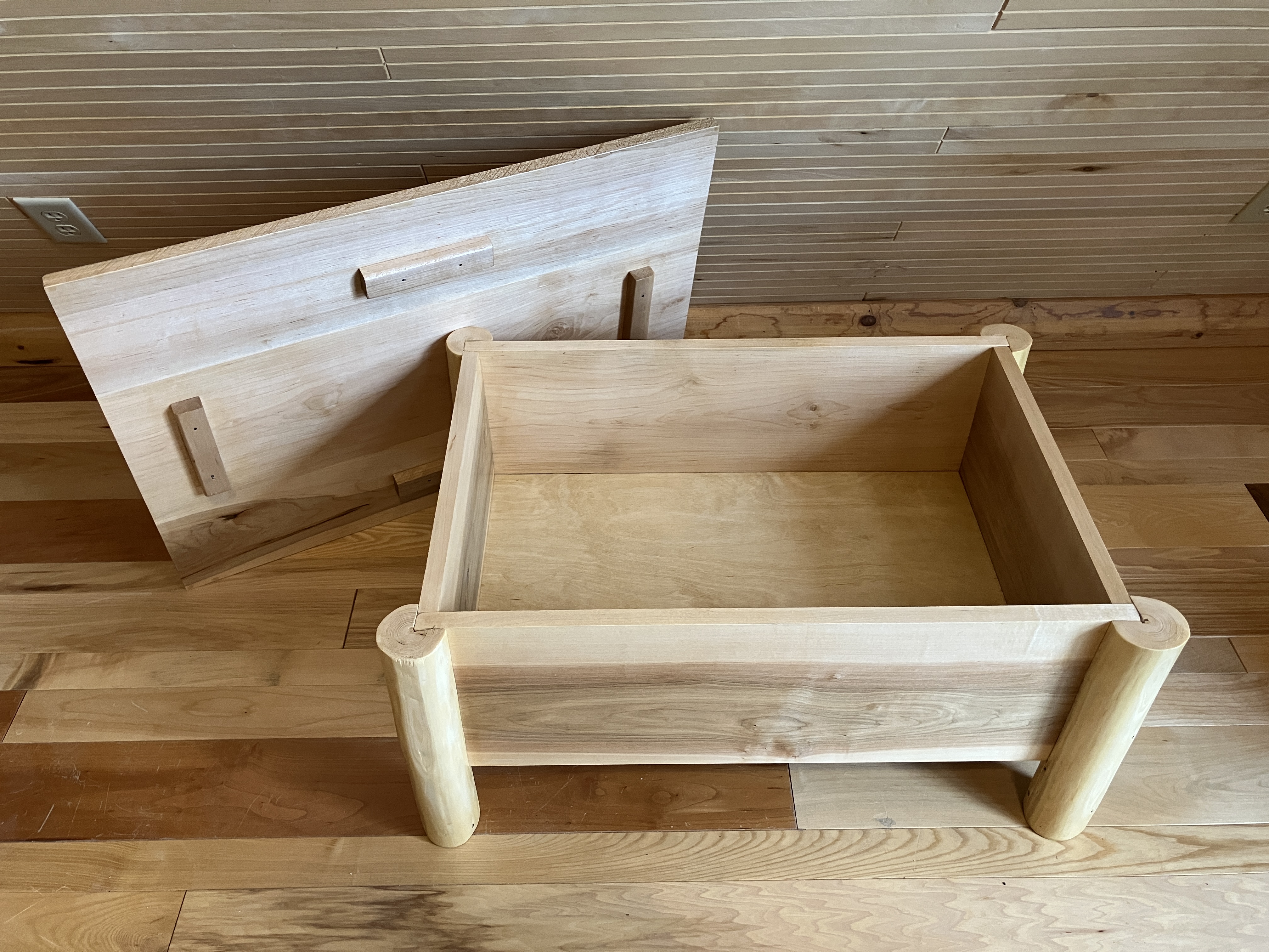 Log storage ottoman with lid open showing interior space