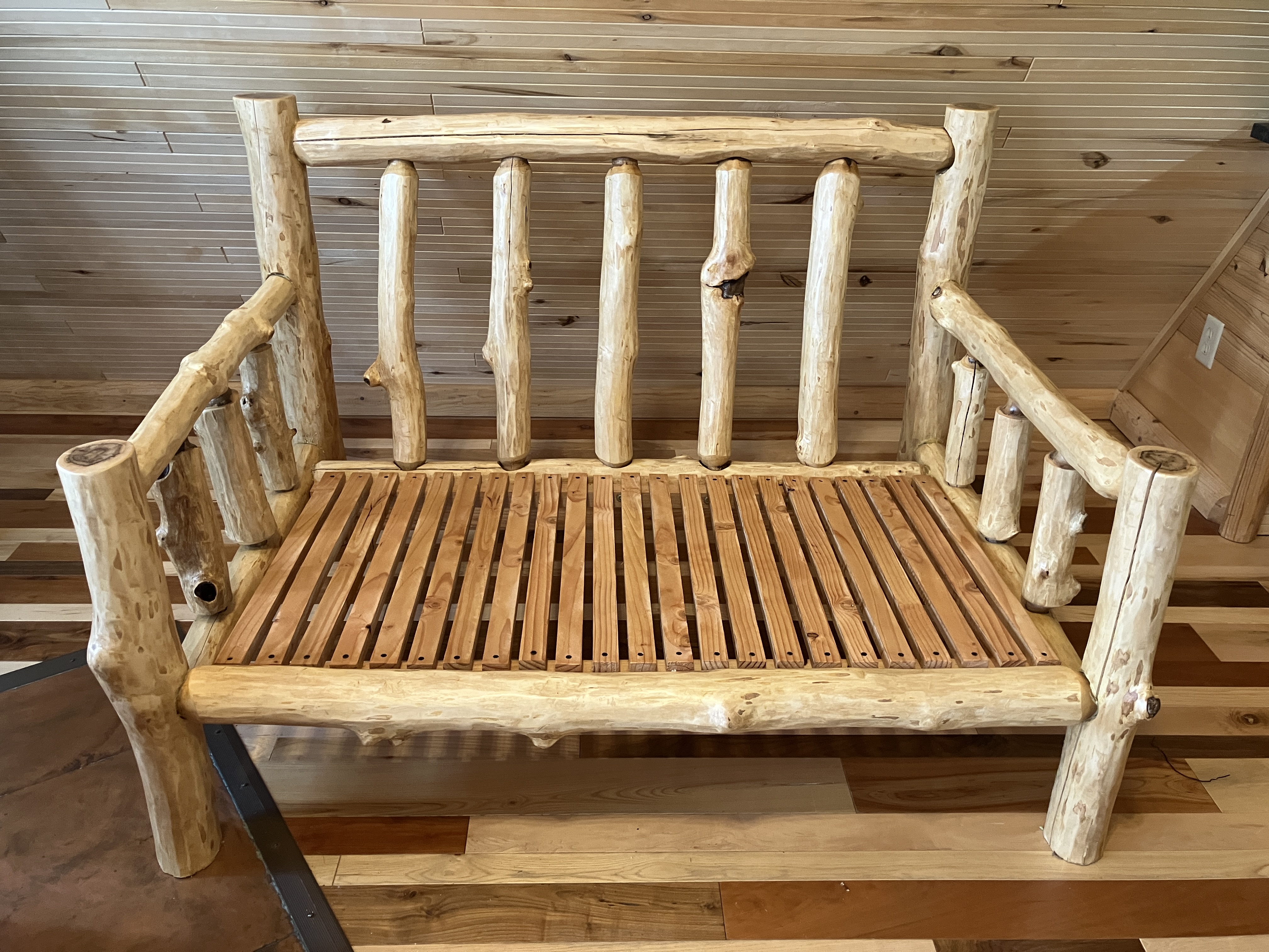 Log sofa in rustic cabin without cushions