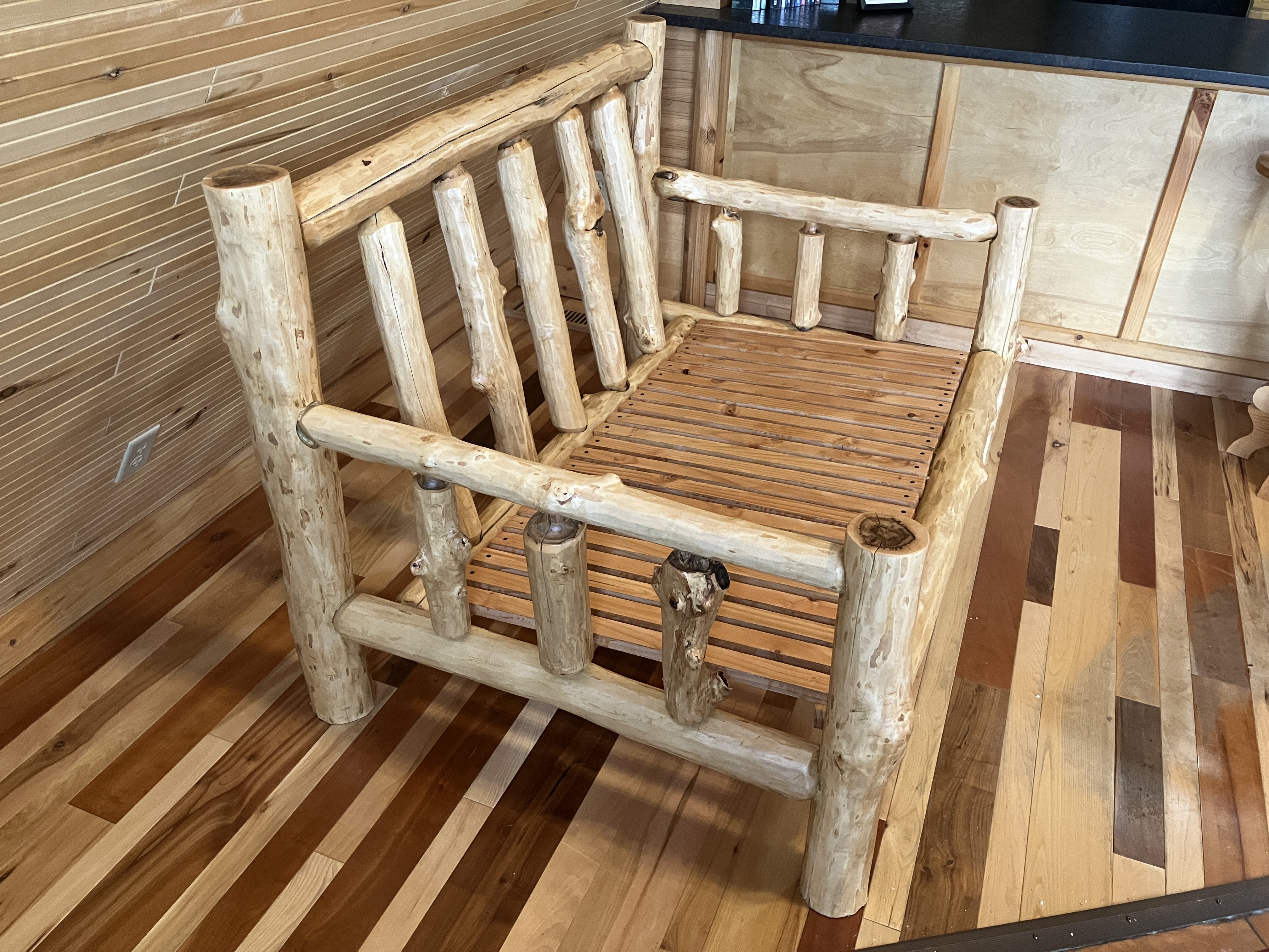 Side profile of log sofa emphasizing log construction