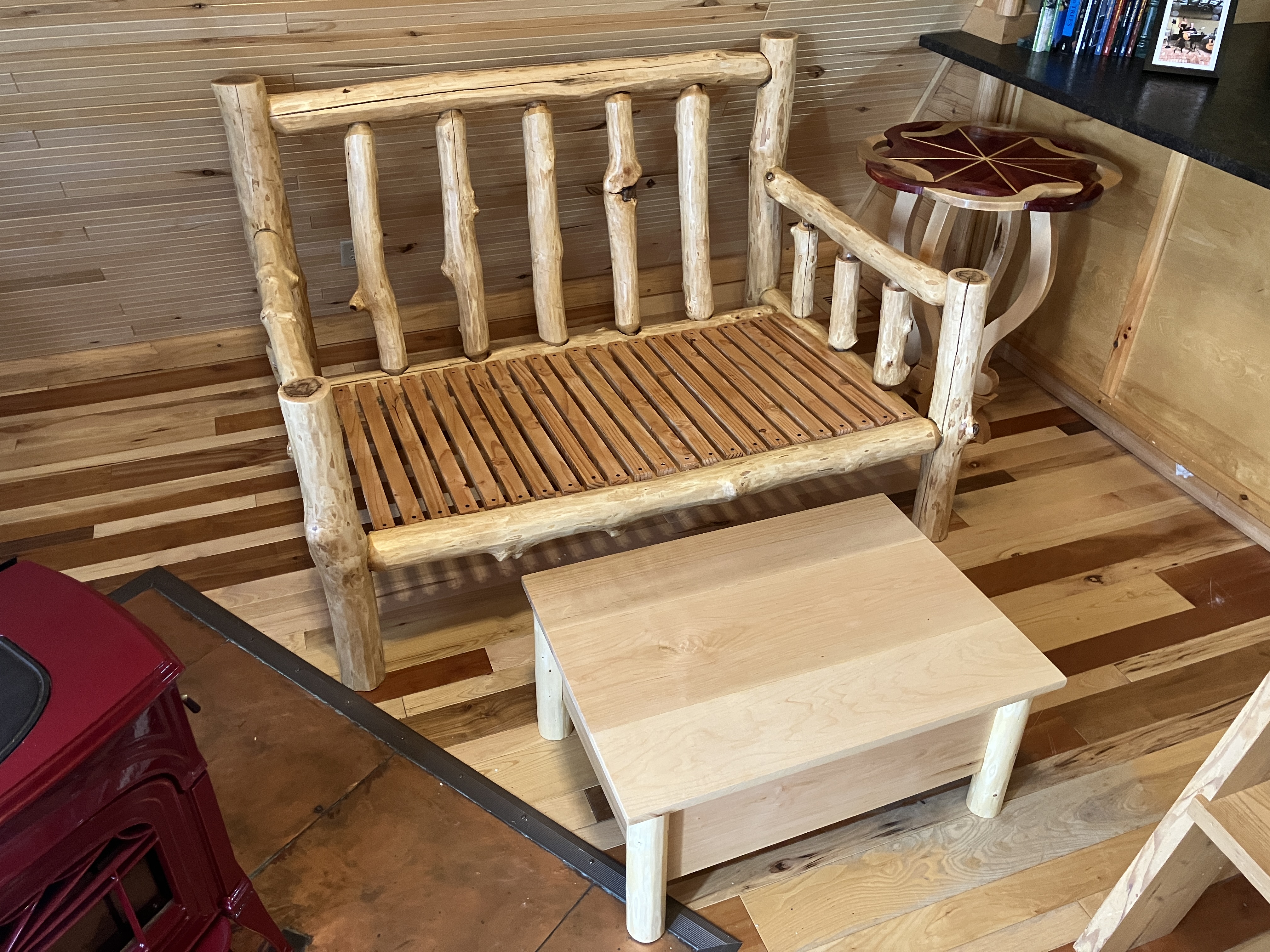 Log sofa with matching storage ottoman and decorative side table in cabin