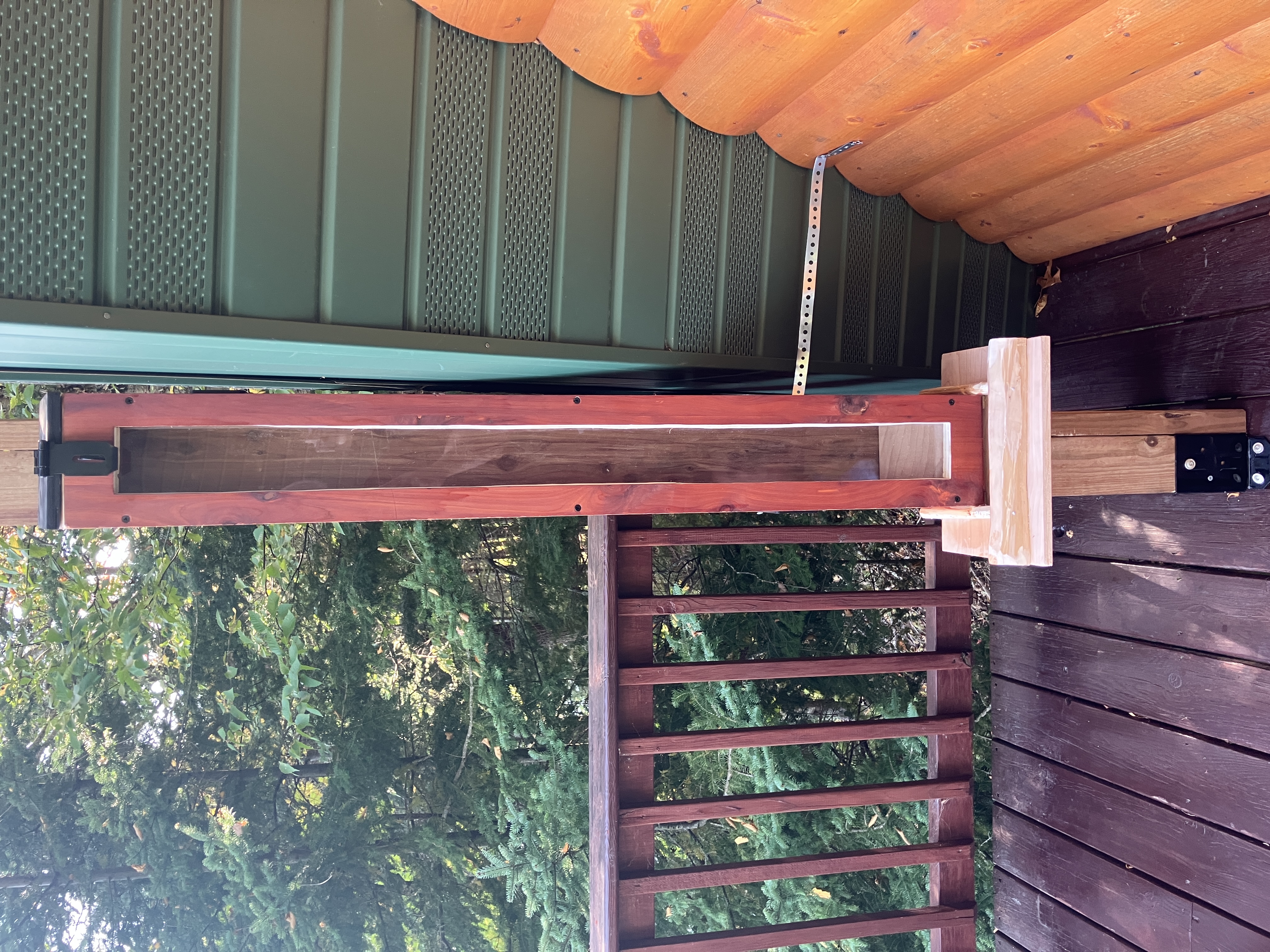 Wooden squirrel feeder mounted on post